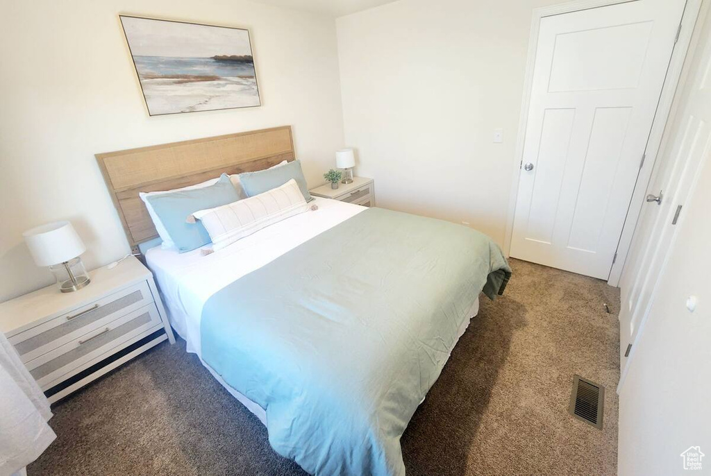 Bedroom featuring dark carpet