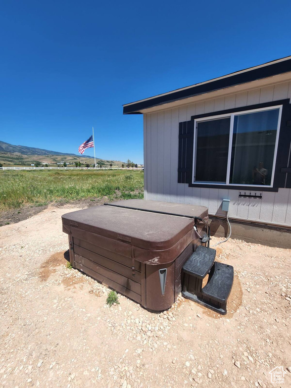View of home\'s exterior with a hot tub