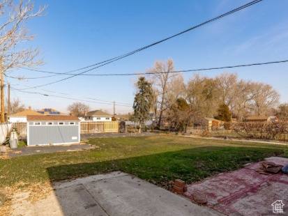 View of yard with a patio and an outdoor structure