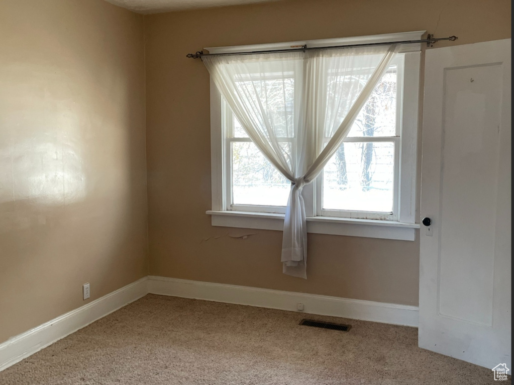 Empty room featuring carpet floors and a textured ceiling