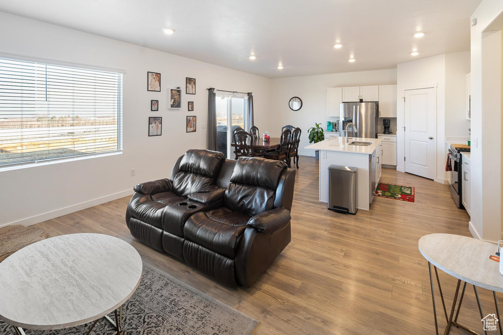 Living room featuring light hardwood / wood-style flooring and sink