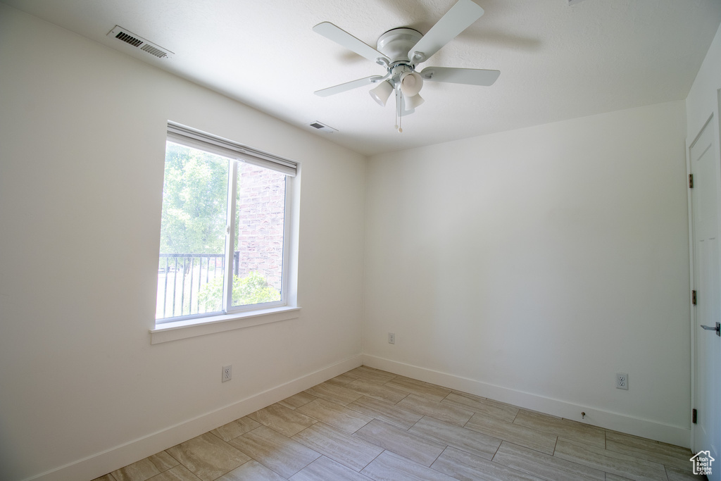 Unfurnished room with ceiling fan and baseboards