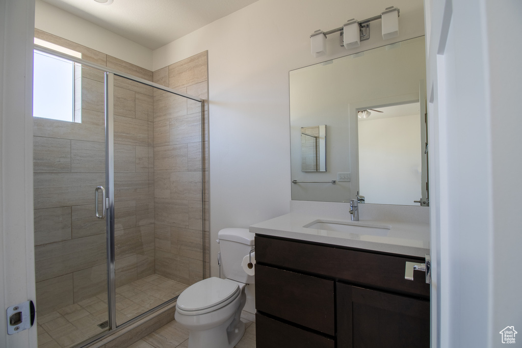 Bathroom featuring vanity and a stall shower