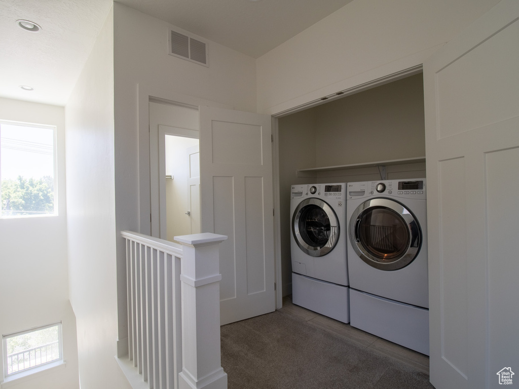 Washroom with separate washer and dryer, plenty of natural light, carpet, and recessed lighting