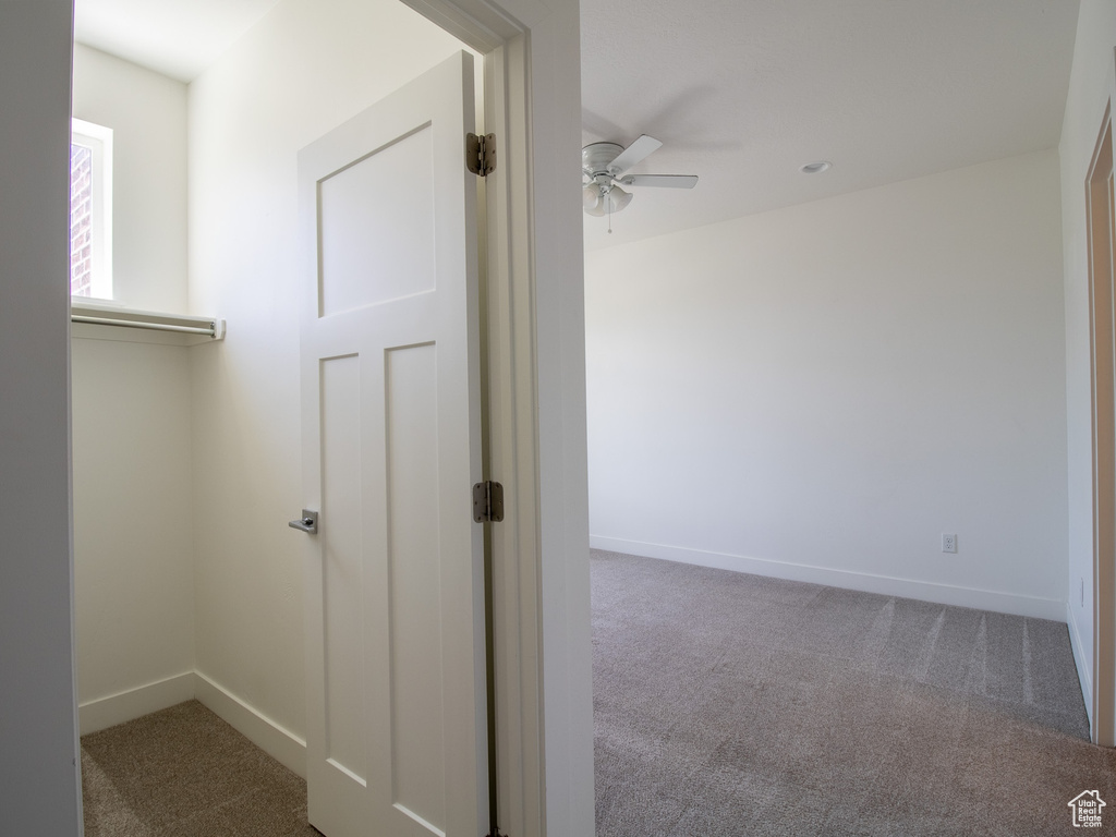 Hall with carpet floors and baseboards