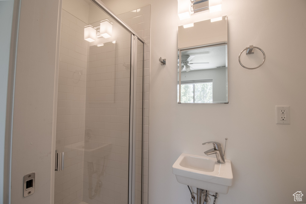 Full bath with a stall shower and a ceiling fan