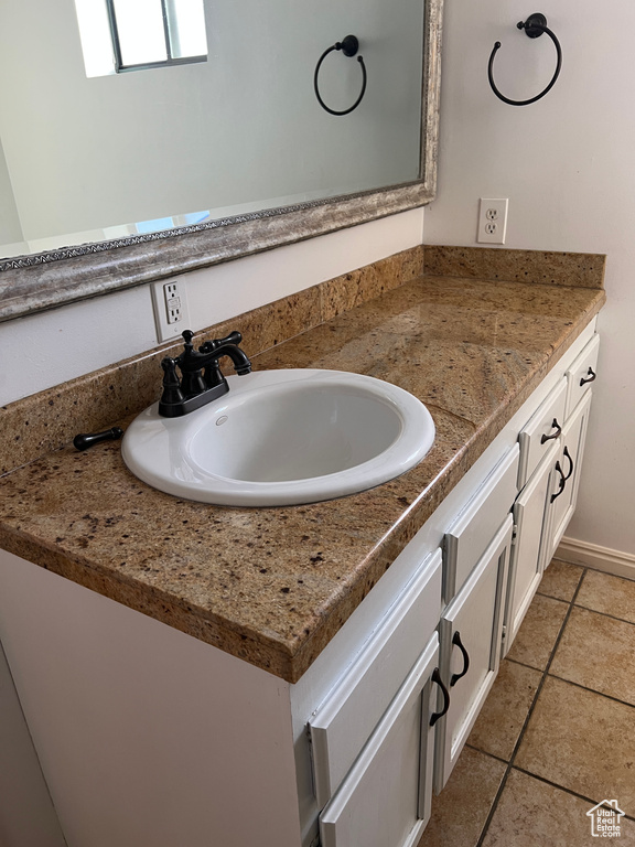 Bathroom with tile patterned flooring and vanity