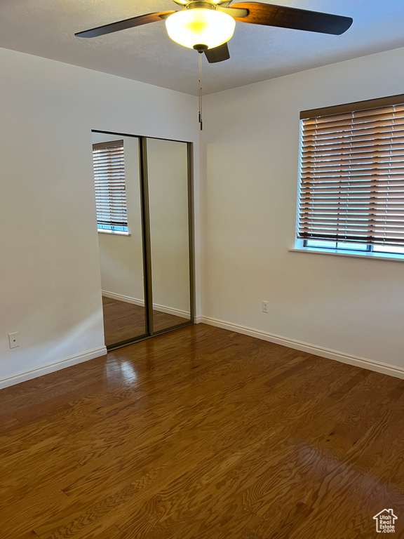 Unfurnished bedroom with a closet, ceiling fan, and hardwood / wood-style floors