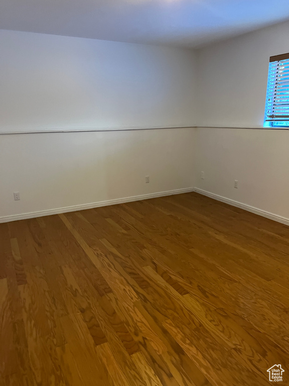 Empty room with hardwood / wood-style floors