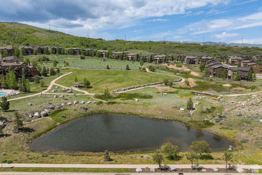 Aerial view of property and surrounding area with nearby suburban area and a water and mountain view