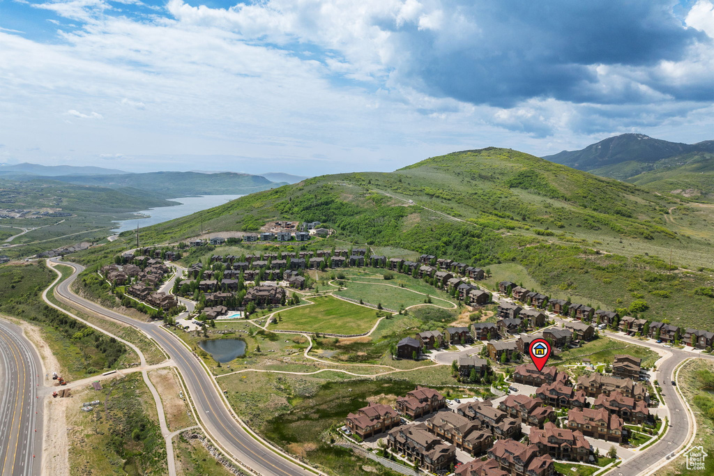 Aerial overview of property\'s location featuring nearby suburban area and a water and mountain view