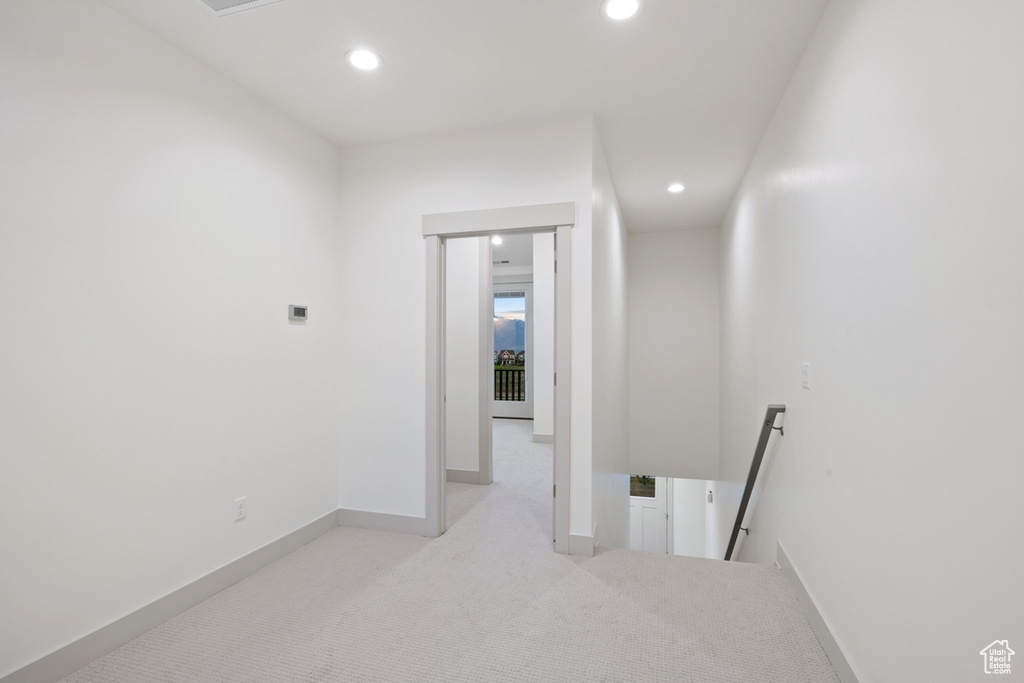 Corridor with an upstairs landing, recessed lighting, carpet, and baseboards