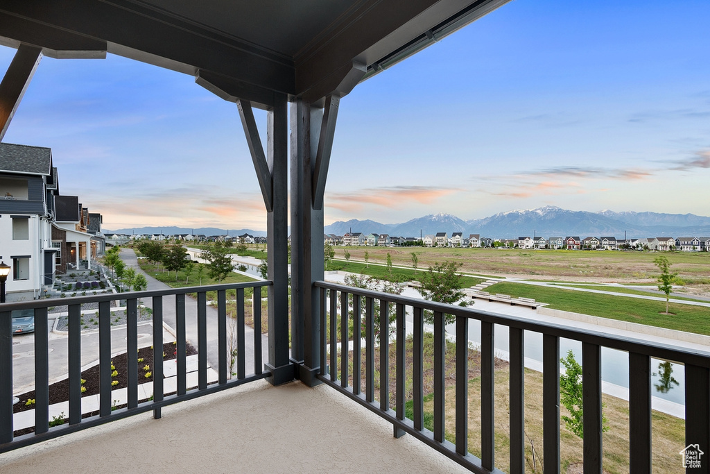 Balcony at dusk featuring a mountain view