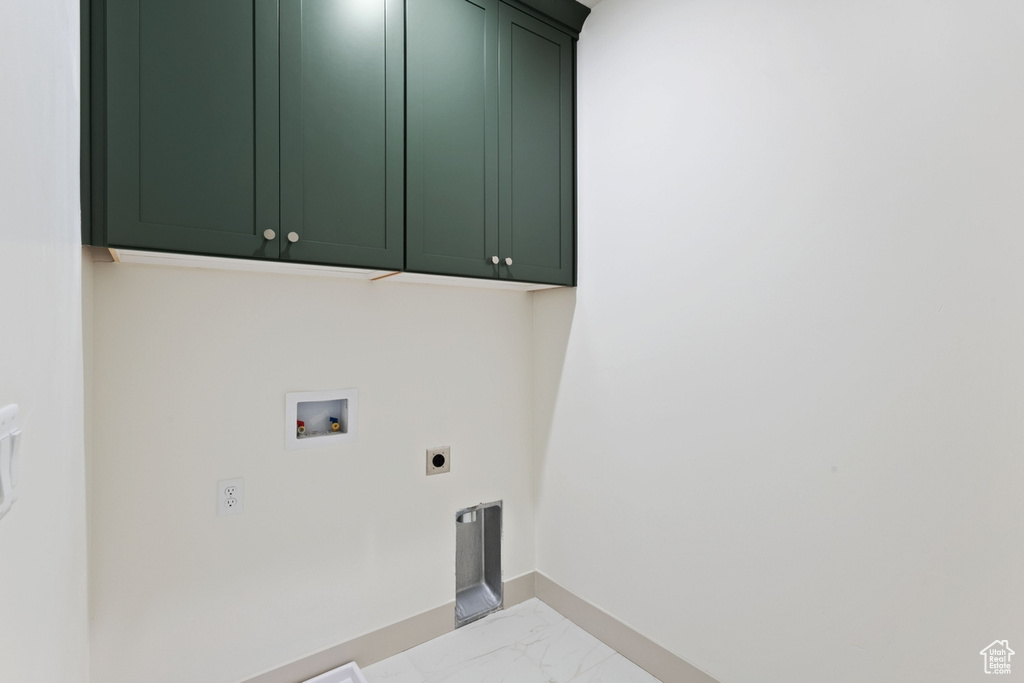 Laundry area featuring electric dryer hookup, cabinet space, marble finish flooring, hookup for a washing machine, and baseboards