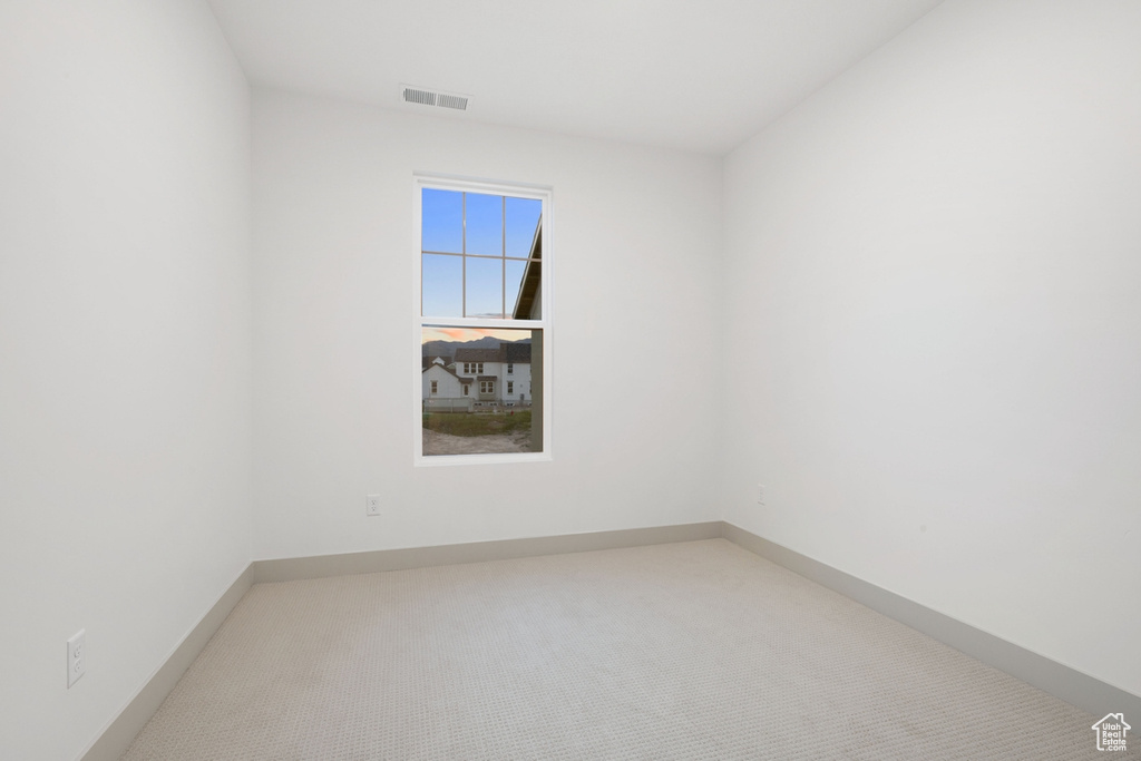 Unfurnished room featuring carpet floors and baseboards