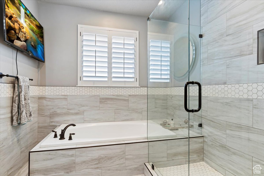 Bathroom with a garden tub and a stall shower