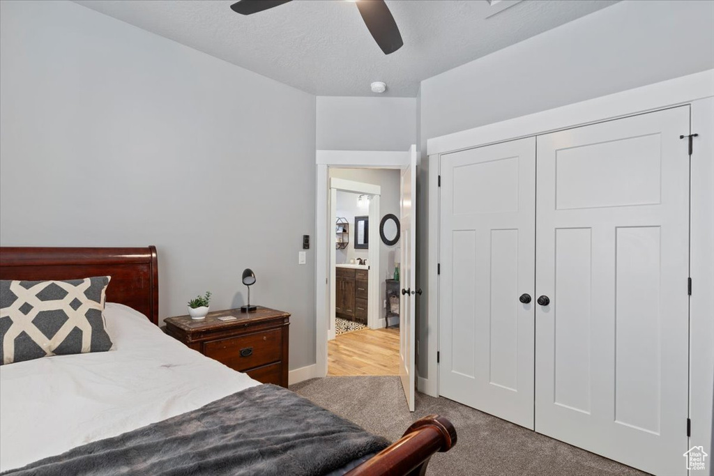 Bedroom featuring carpet flooring, a closet, and ceiling fan