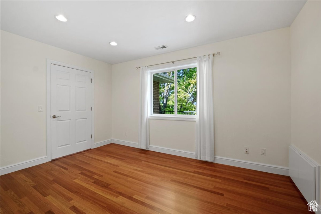 Unfurnished room featuring hardwood / wood-style flooring