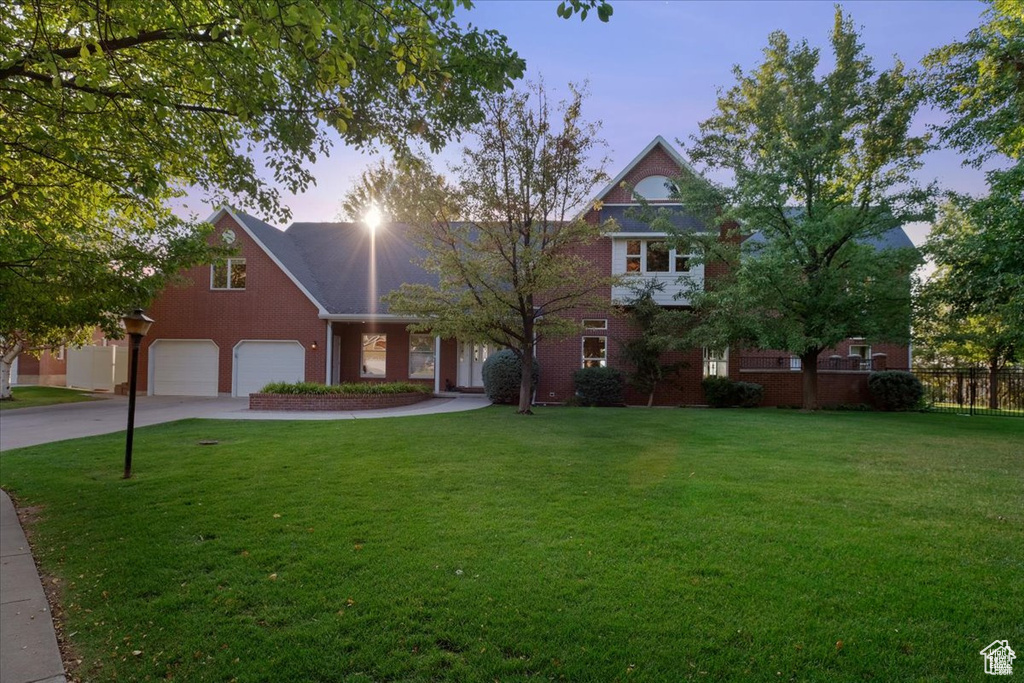 View of front of house with a lawn and a garage