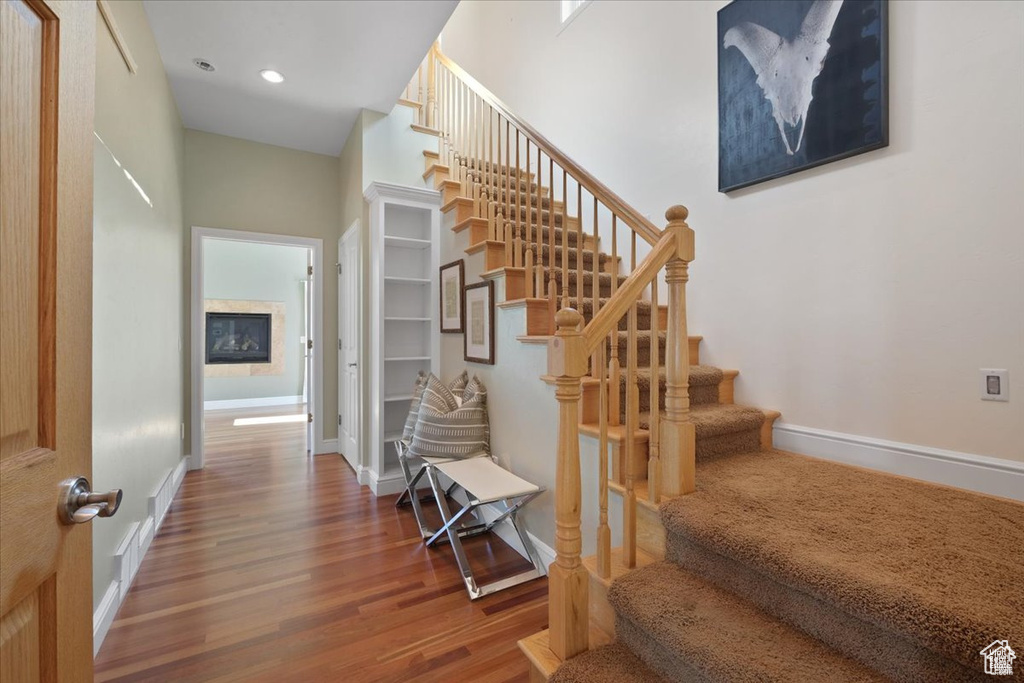 Stairway featuring hardwood / wood-style floors