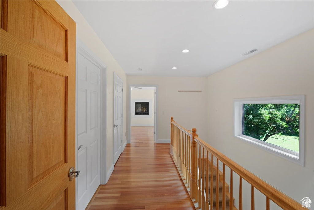 Hall with light hardwood / wood-style flooring