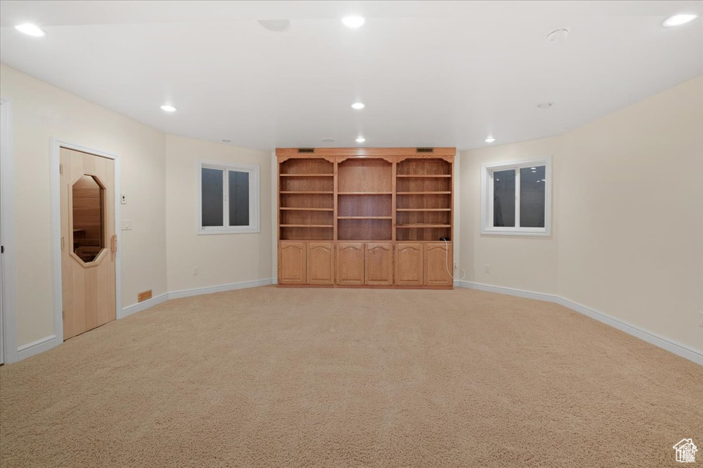 Unfurnished living room featuring light carpet