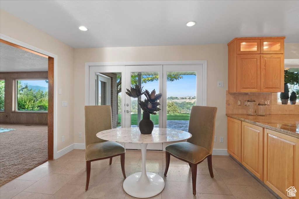 Dining area with plenty of natural light and light tile patterned floors