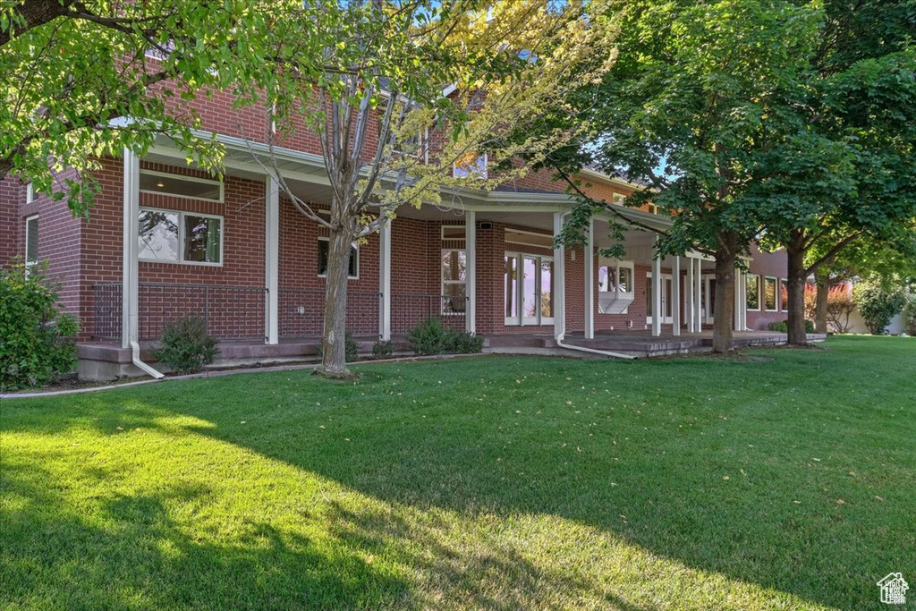 View of front of property with a porch and a front yard