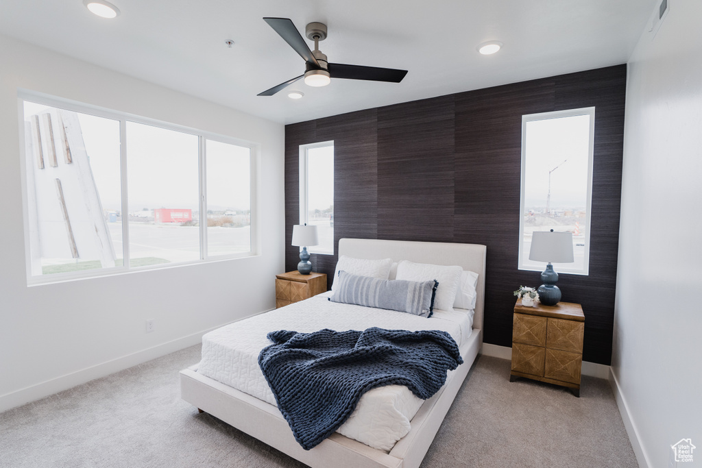 Carpeted bedroom featuring ceiling fan