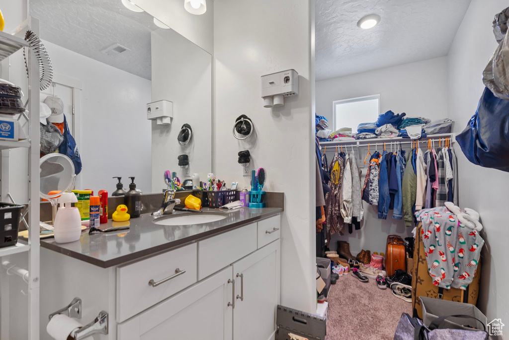 Bathroom featuring vanity and a textured ceiling