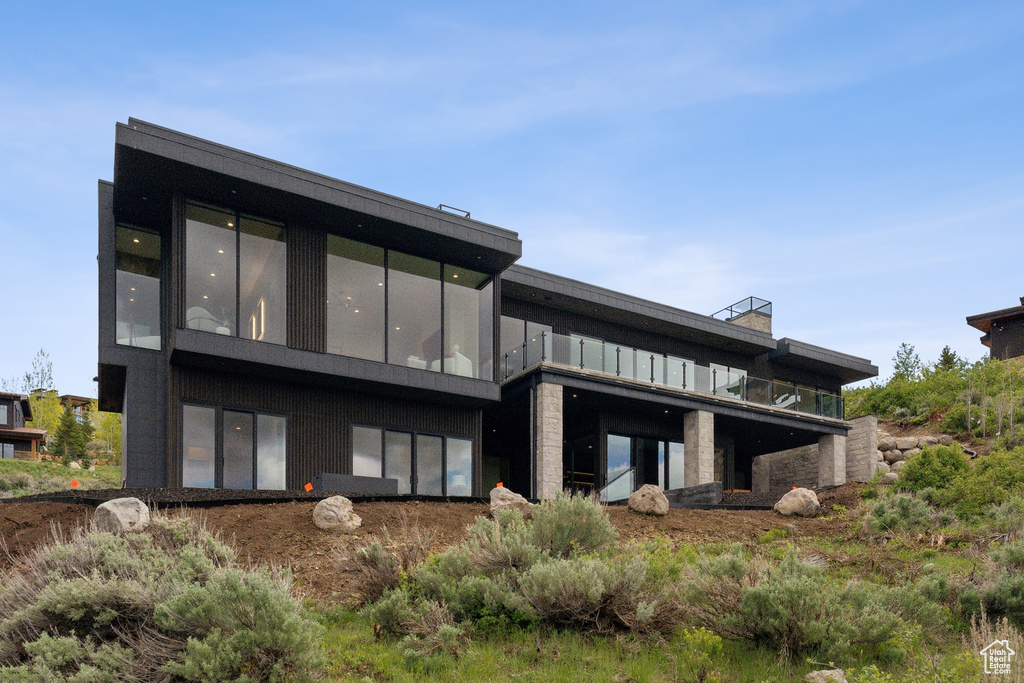 Back of house featuring a balcony