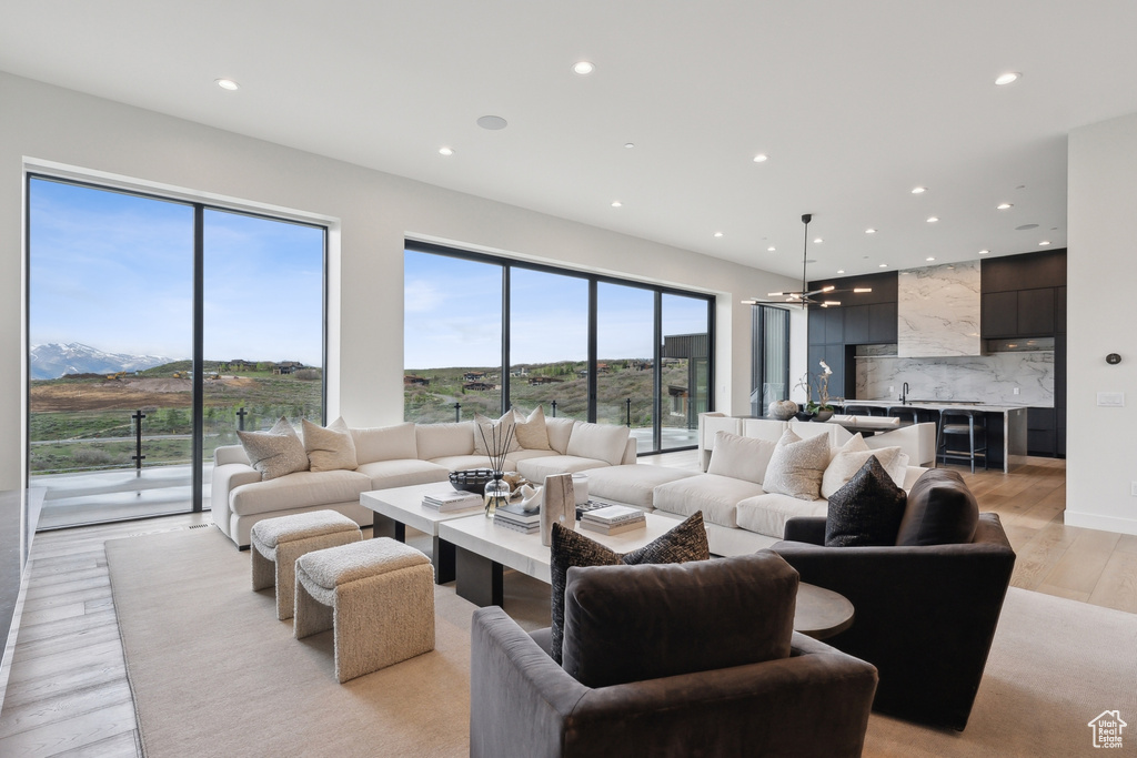 Living area featuring light wood-style floors and recessed lighting