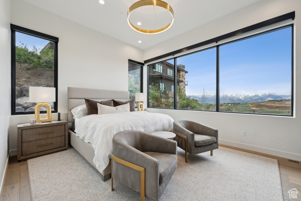 Bedroom featuring wood finished floors, recessed lighting, and baseboards
