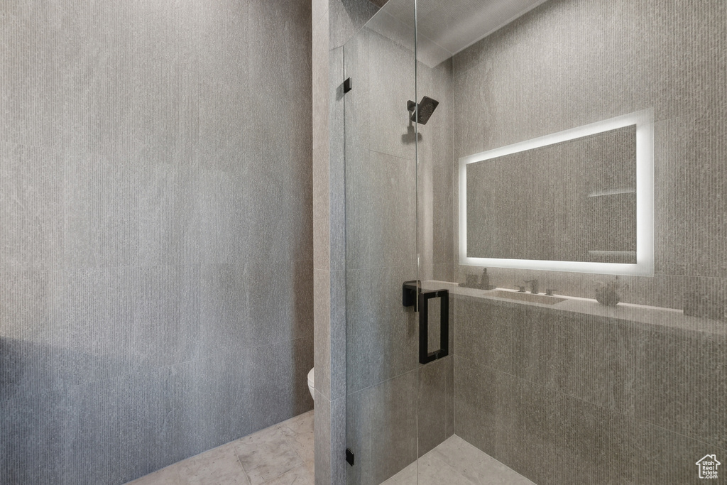 Bathroom with a shower stall and toilet