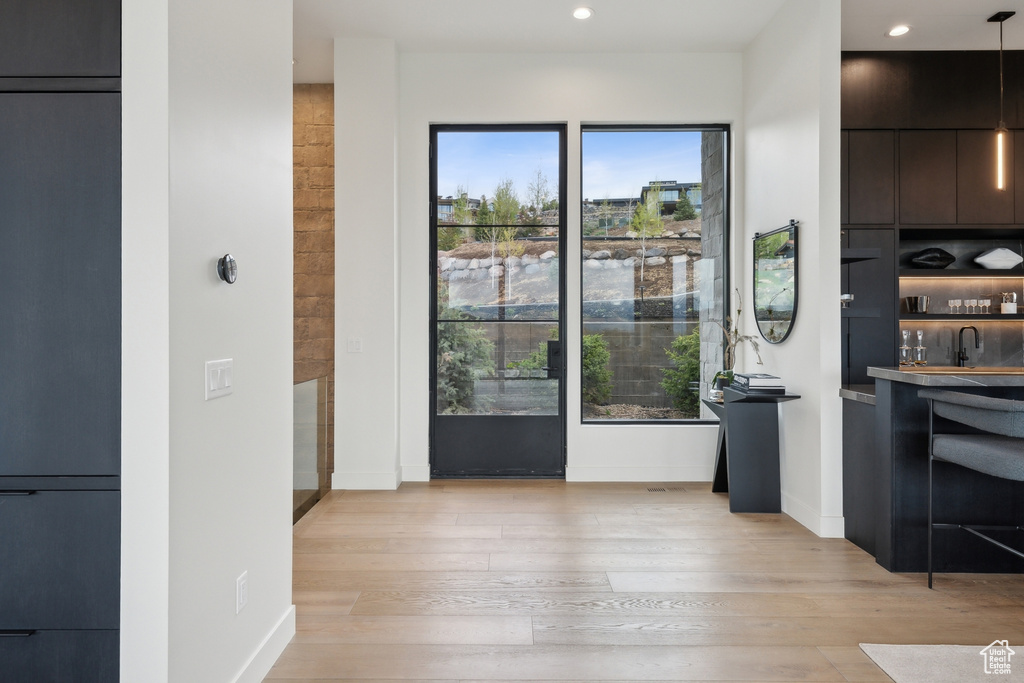 Dining area featuring plenty of natural light, light wood-style flooring, recessed lighting, and baseboards