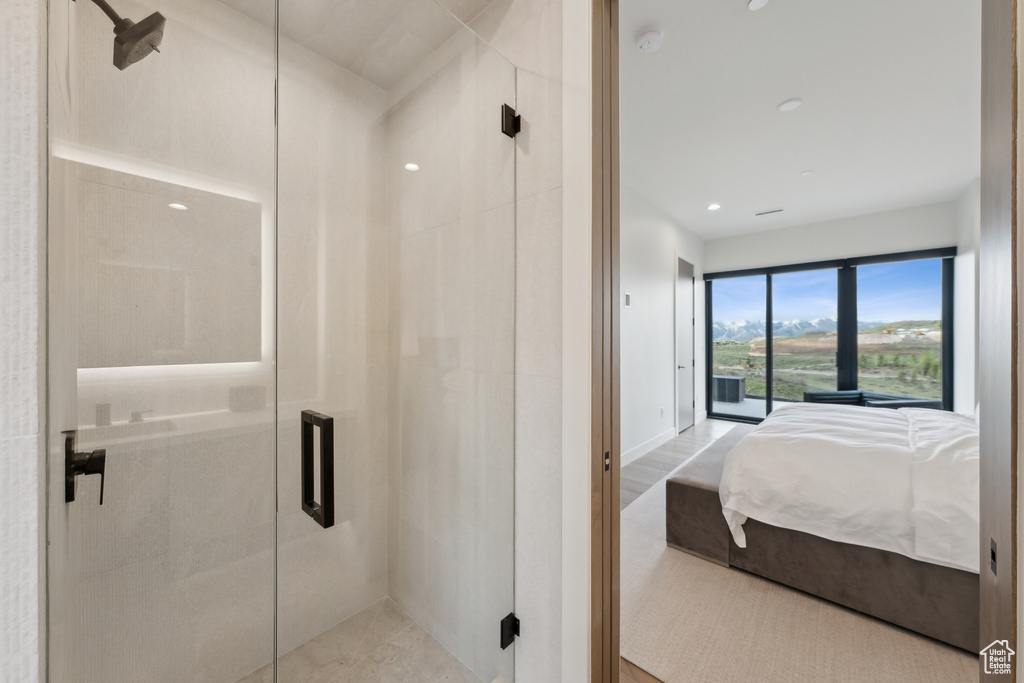 Bathroom with a shower stall, ensuite bathroom, and baseboards