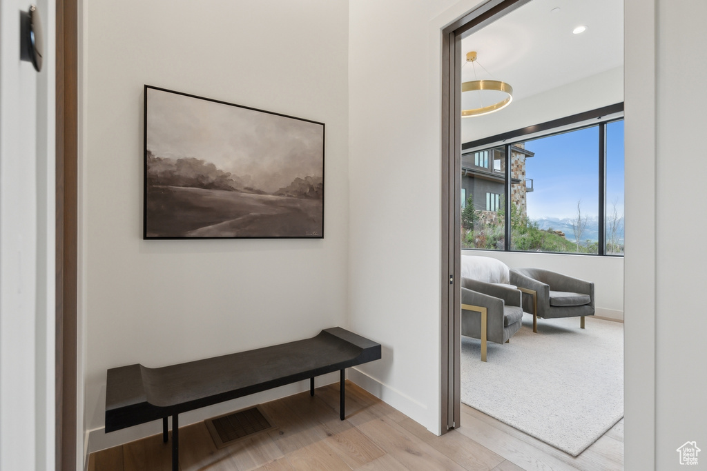 Hall with wood finished floors and baseboards