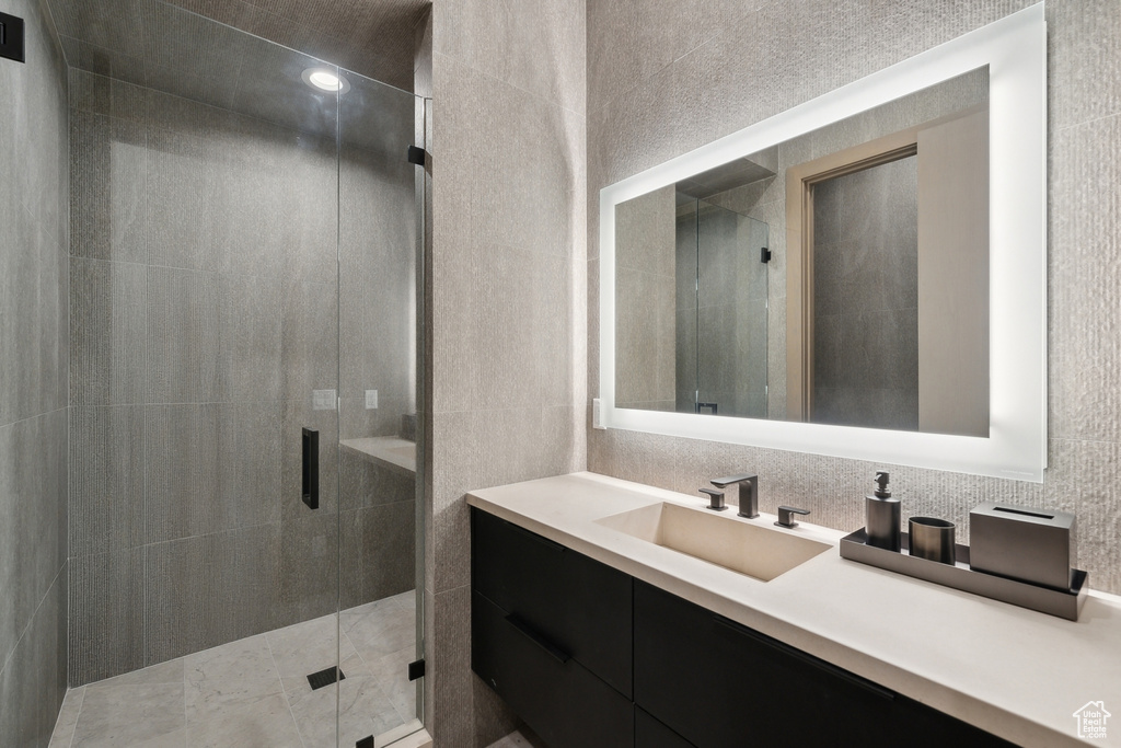 Full bath with a shower stall and vanity