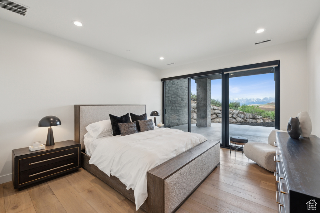 Bedroom with access to outside, recessed lighting, and light wood-type flooring