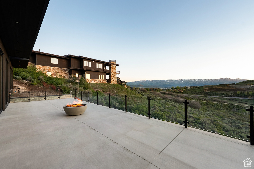 View of patio / terrace featuring a fire pit and a mountain view