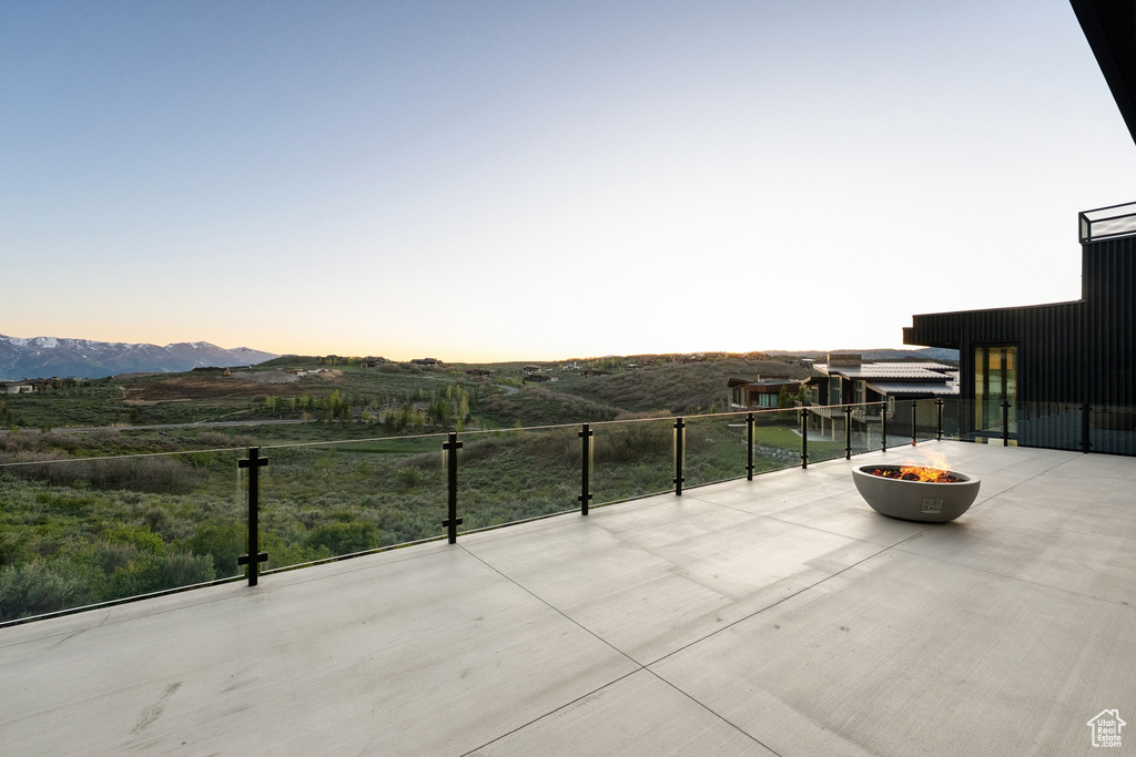 View of patio / terrace featuring a fire pit and a mountain view