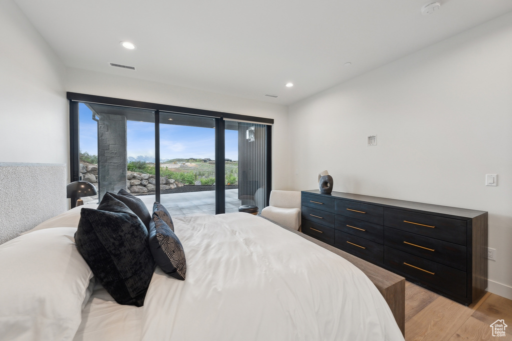 Bedroom featuring access to outside, light wood finished floors, and recessed lighting