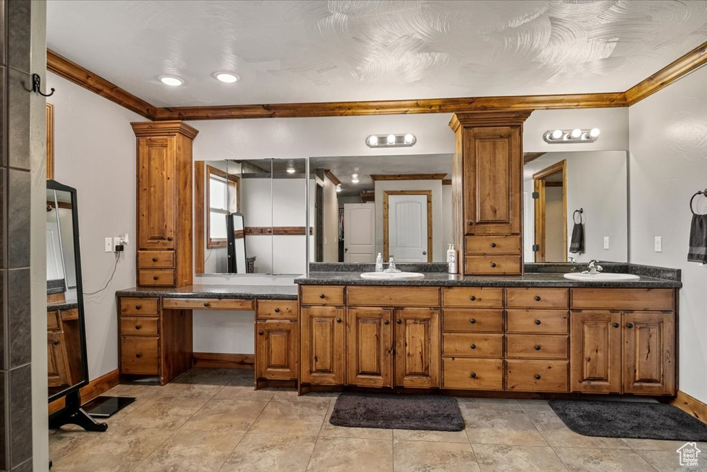 Bathroom with vanity, ornate columns, and ornamental molding