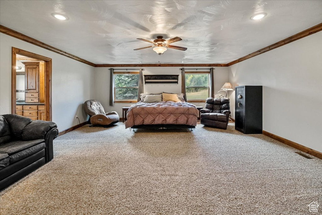 Bedroom with carpet flooring, ceiling fan, and ornamental molding