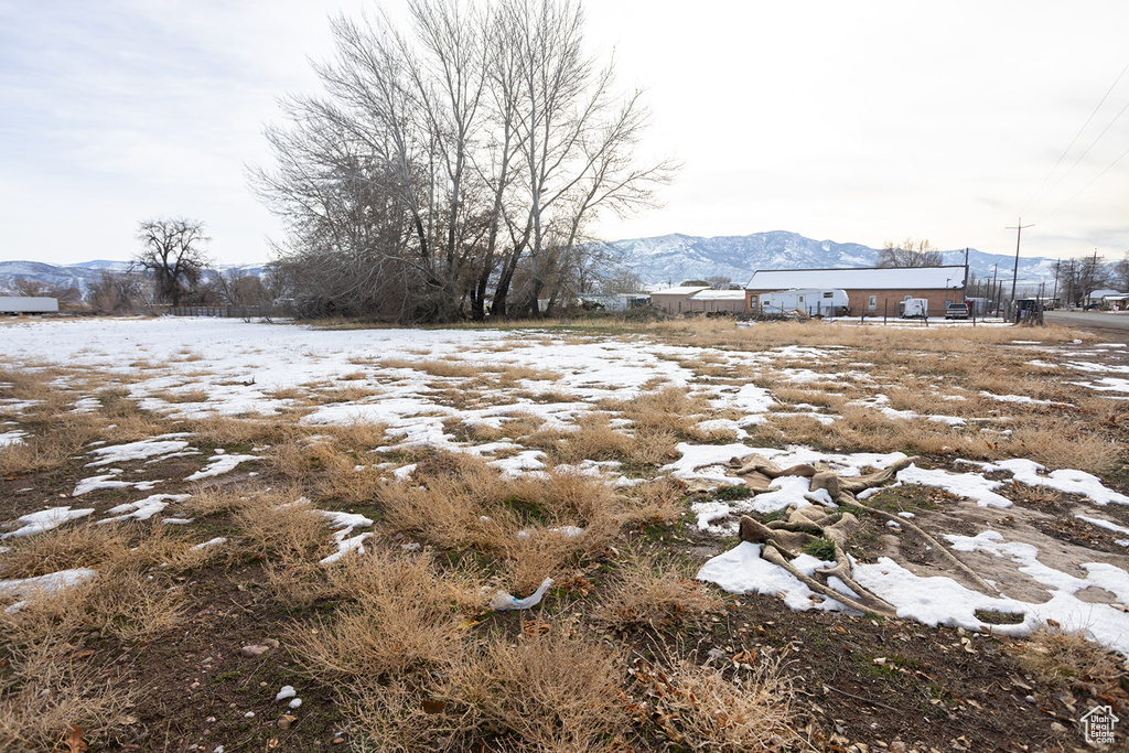 Snowy yard featuring a mountain view