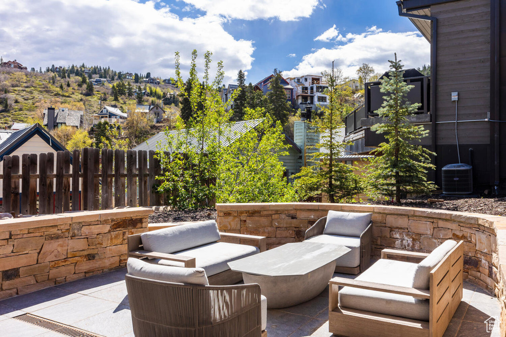 View of patio / terrace featuring central AC unit, a residential view, and an outdoor hangout area