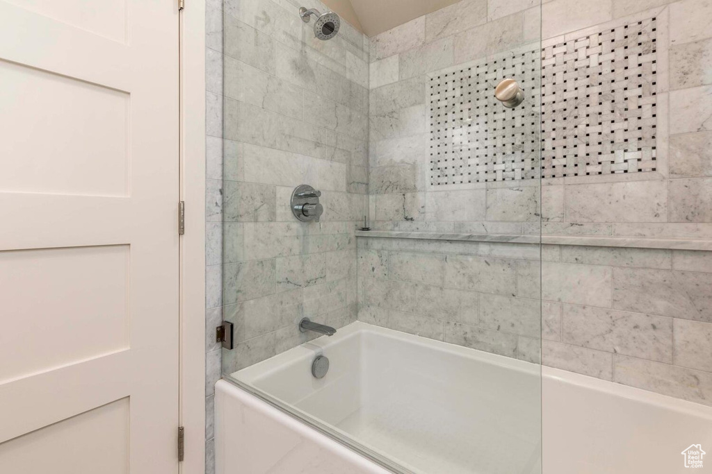 Full bath with combined bath / shower with glass door