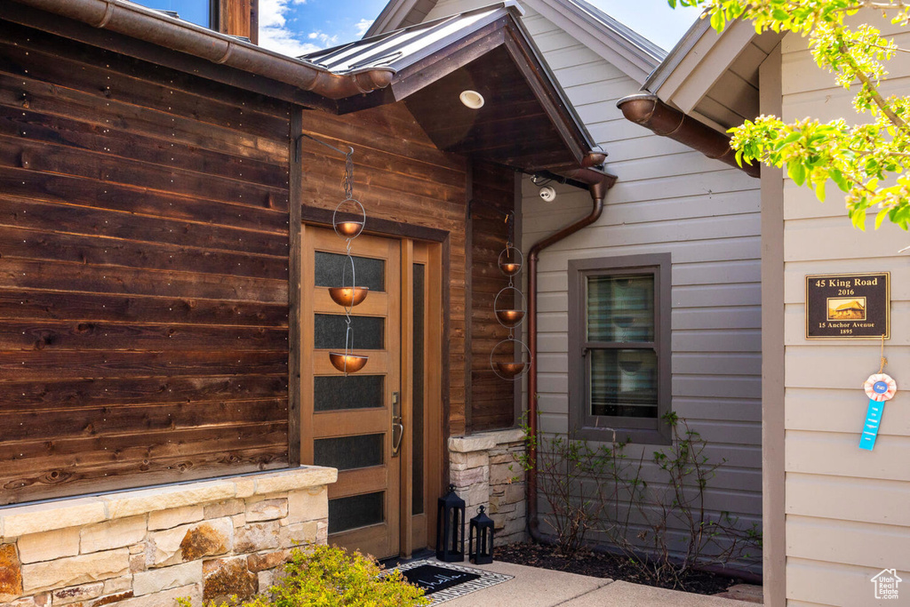 Doorway to property featuring stone siding