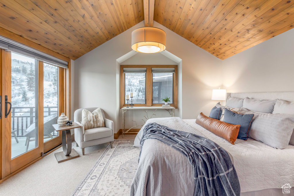 Bedroom with vaulted ceiling, access to exterior, and carpet floors