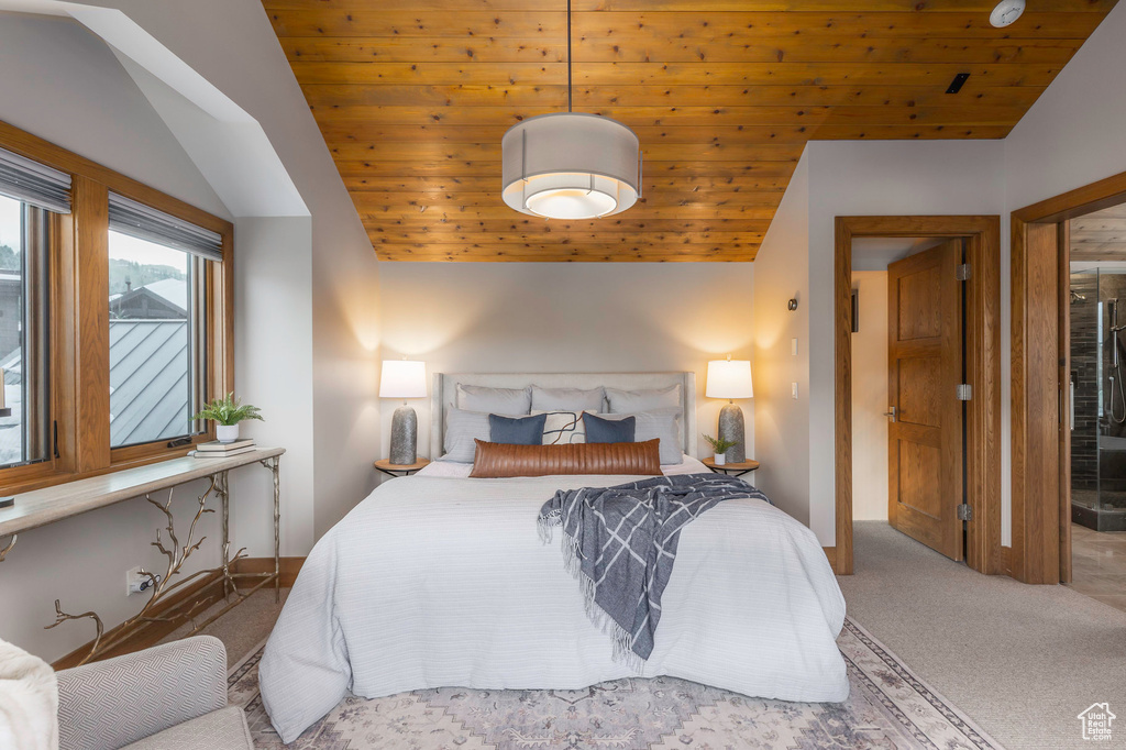 Carpeted bedroom with lofted ceiling and wood ceiling
